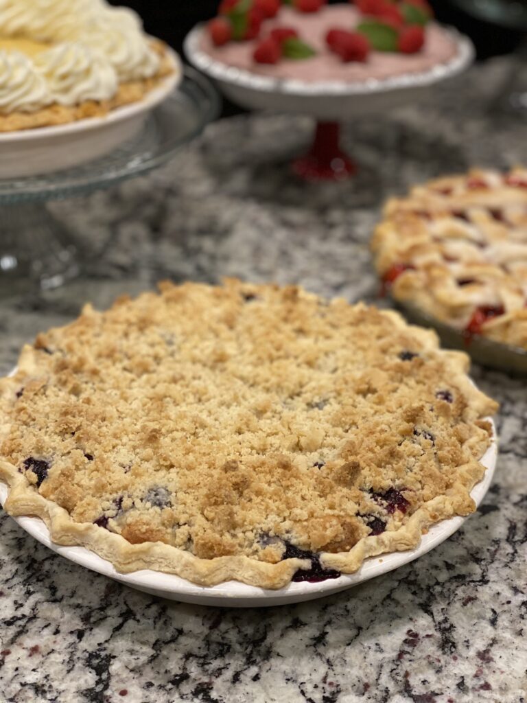 Blueberry cream pie with crumb topping in a pie dish