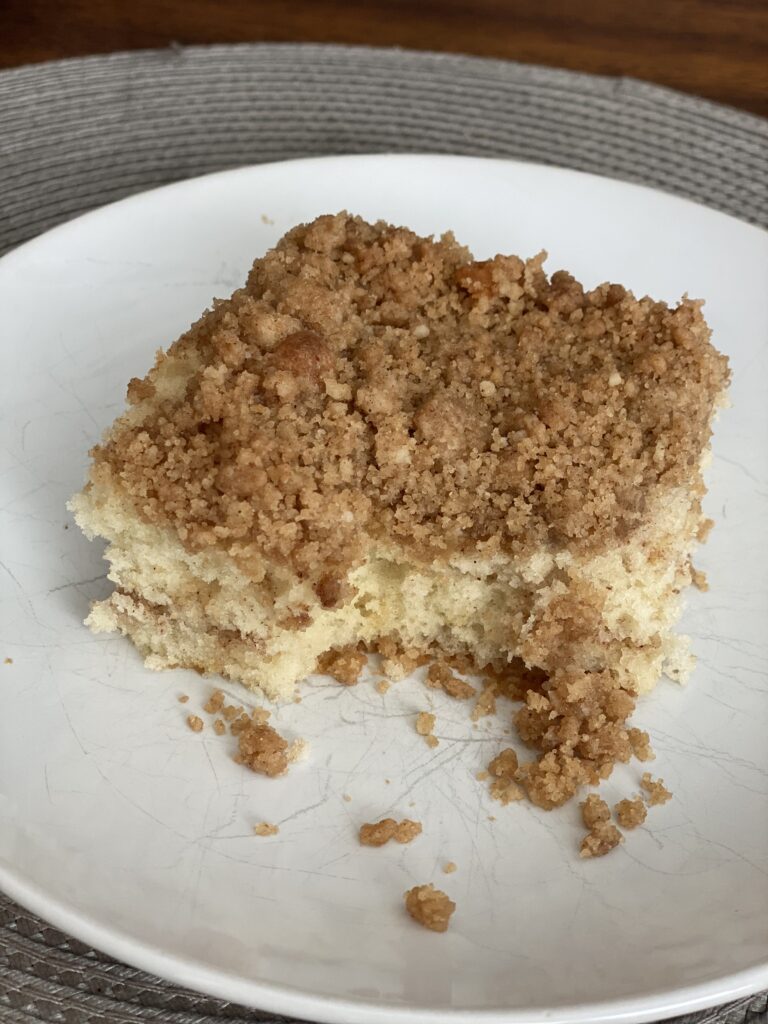 Slice of homemade cinnamon coffee cake with a thick streusel topping and cinnamon swirl