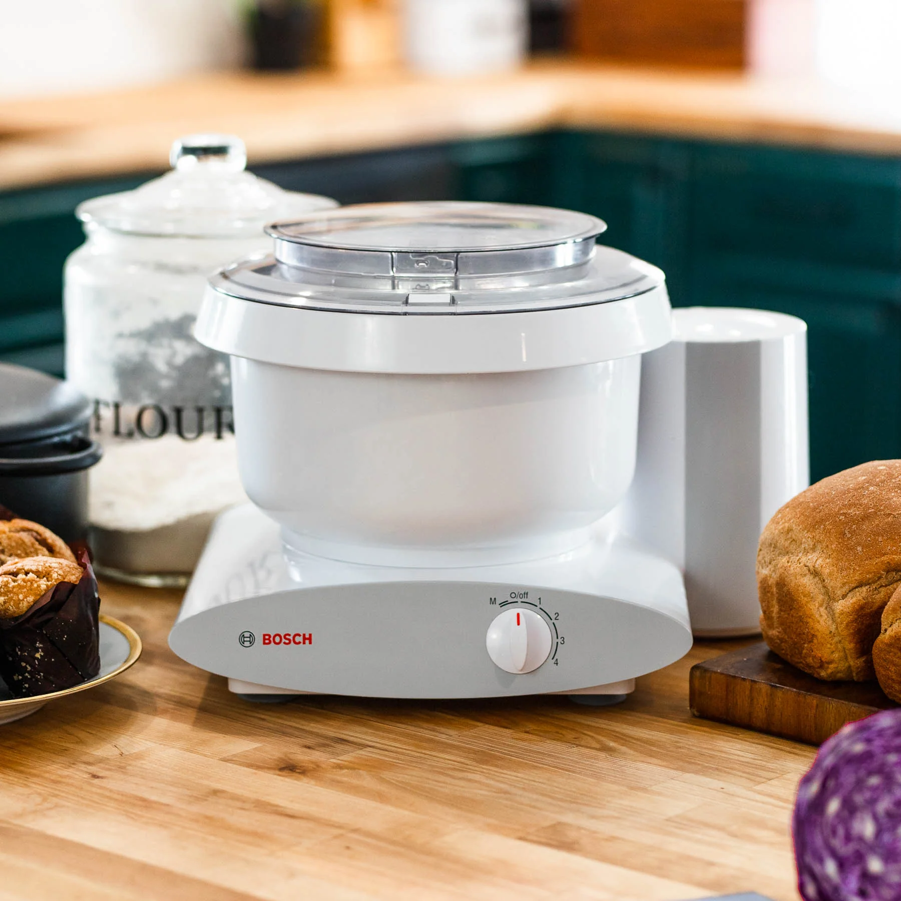 Bosch Universal Mixer on a kitchen counter with attachments.