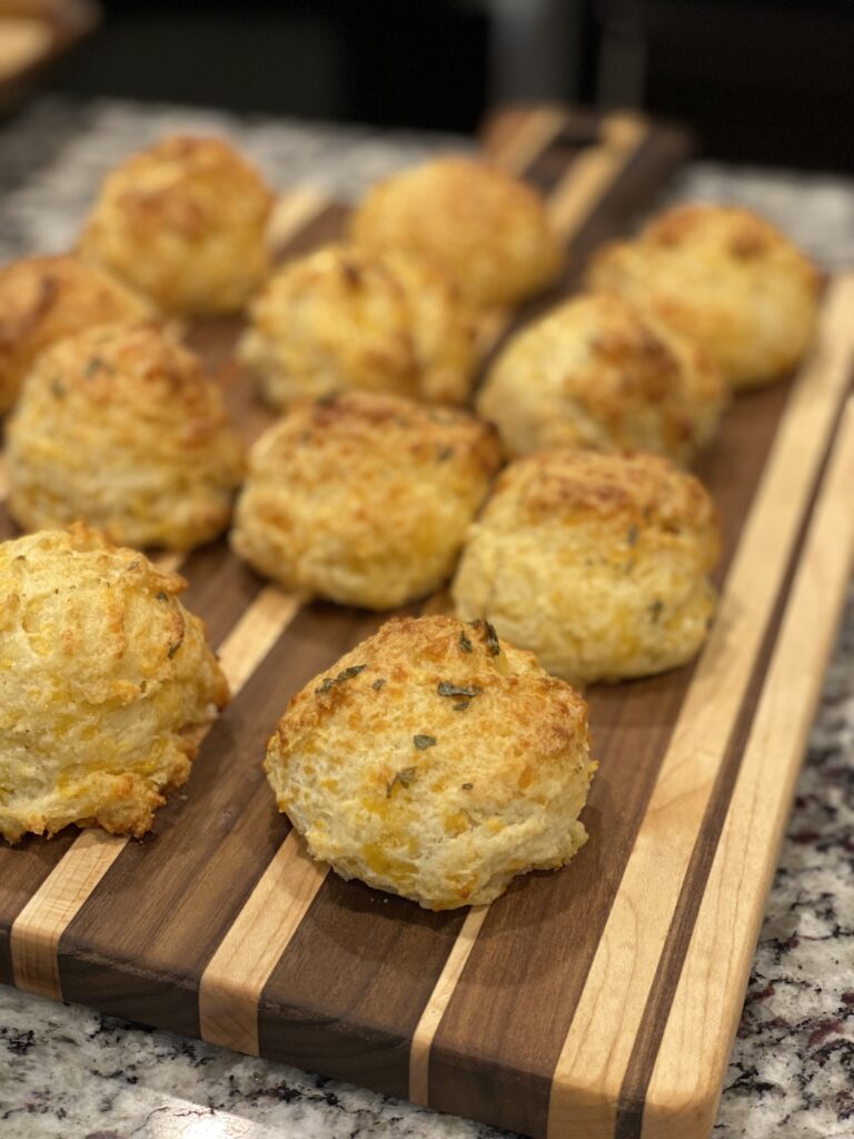 Stack of cheesy garlic biscuits brushed with melted butter