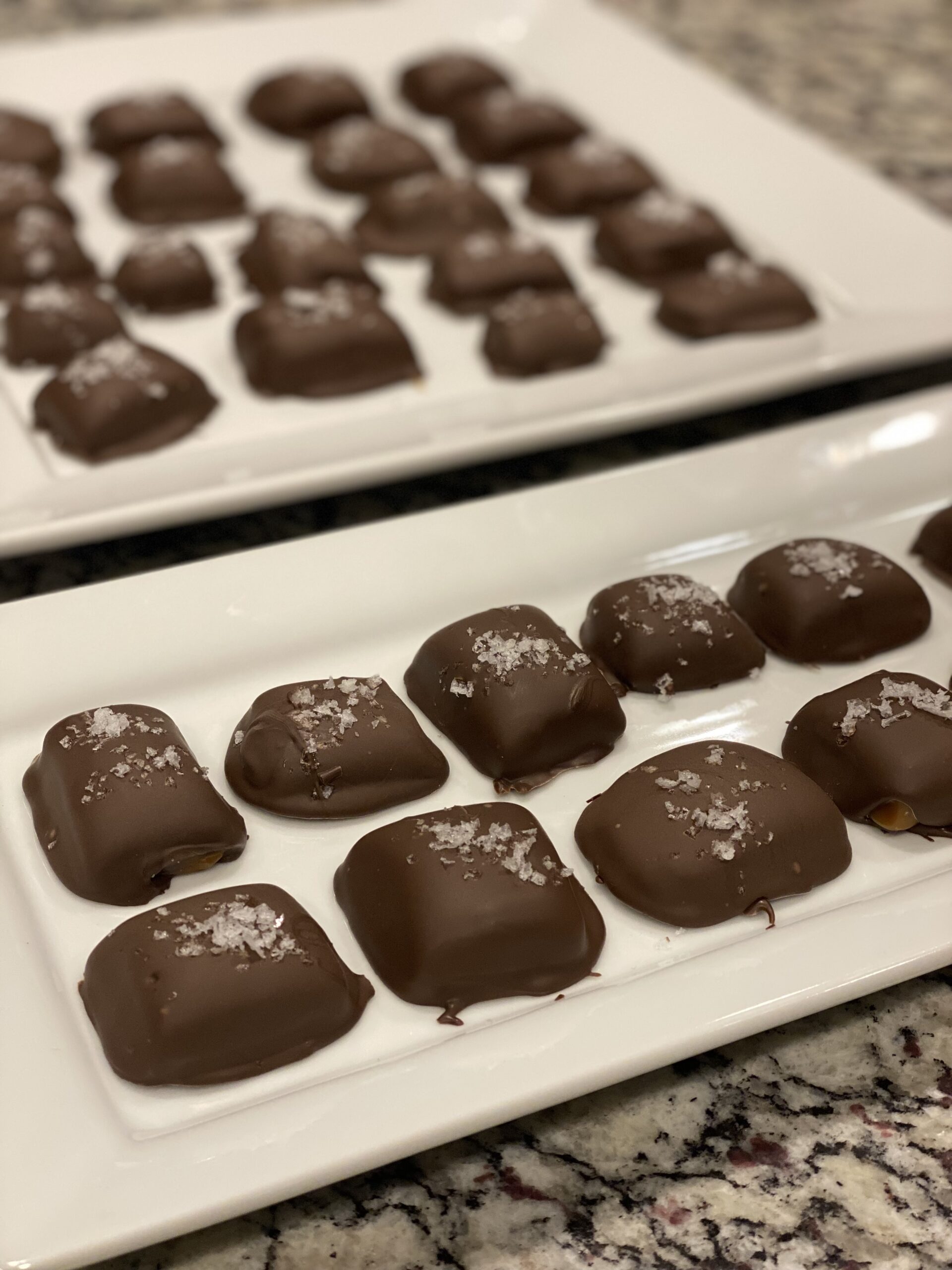 Bite-size chocolate-dipped caramels with sea salt sprinkled on top
