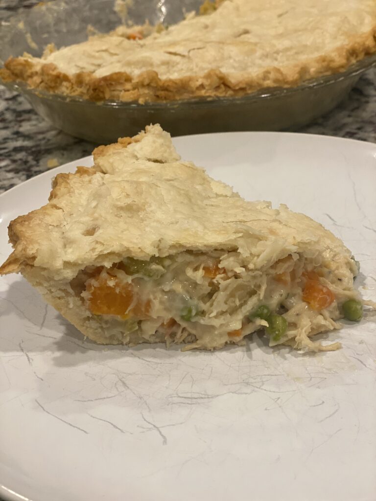 Homemade chicken pot pie with a golden flaky crust and creamy chicken and vegetable filling.