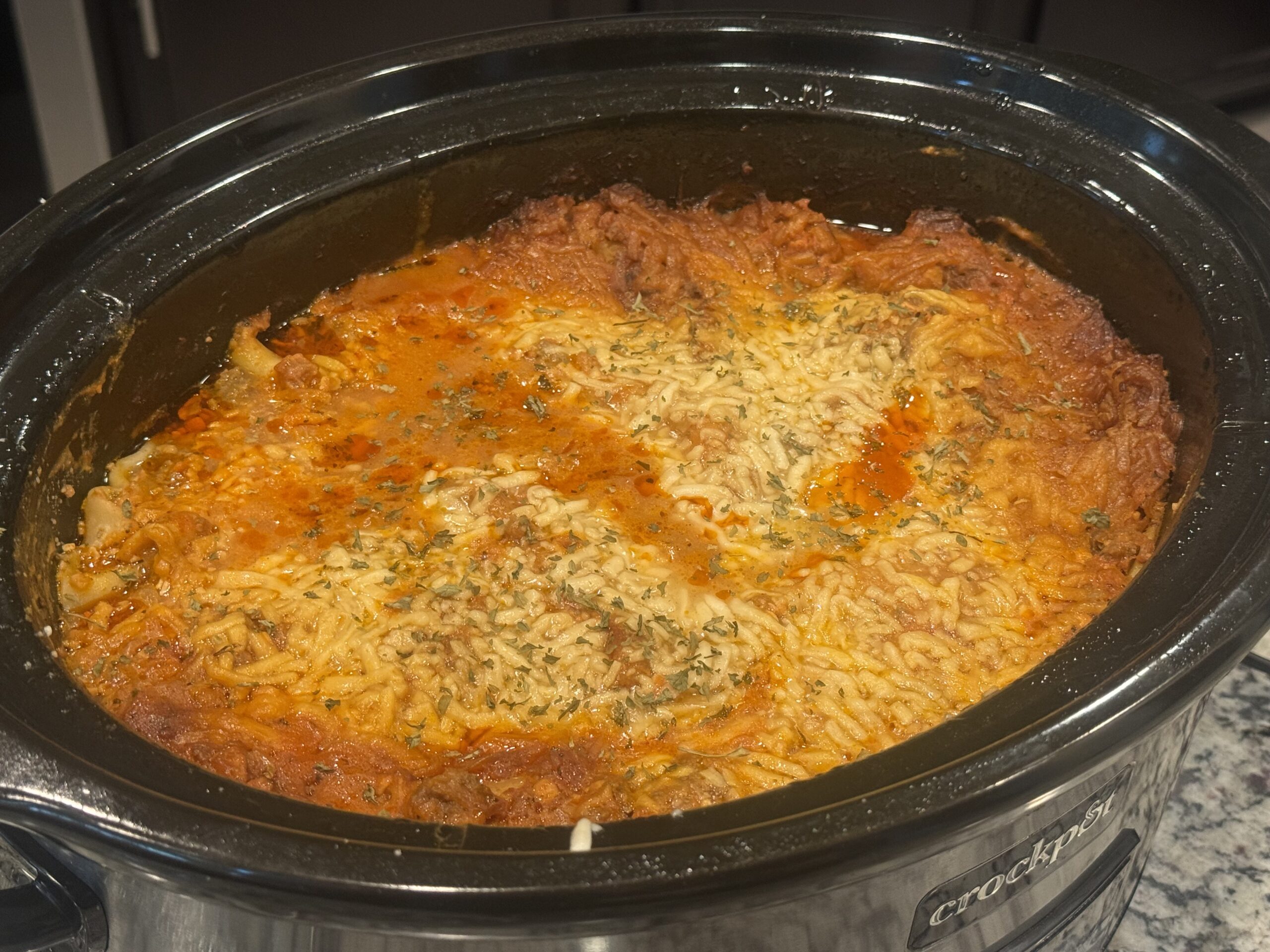Slice of easy Crockpot Lasagna made with layers of ground beef, rich pasta sauce, creamy cheese filling, tender lasagna noodles, and melted mozzarella cheese.